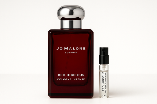 Jo Malone Red Hibiscus Cologne Intense 1 ml staaltje standing next to 100 ml perfume bottle of Jo Malone Red Hibiscus Cologne Intense which has white writing on dark red bottle